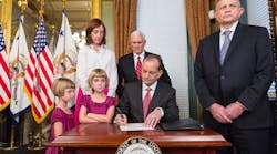 Alexander Acosta signs paperwork after being sworn in as secretary of the Department of Labor in April. (Photo: The White House)