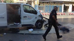 The white van seen here reportedly mowed down pedestrians in central Barcelona, killing 14 people. (Photo via Twitter)