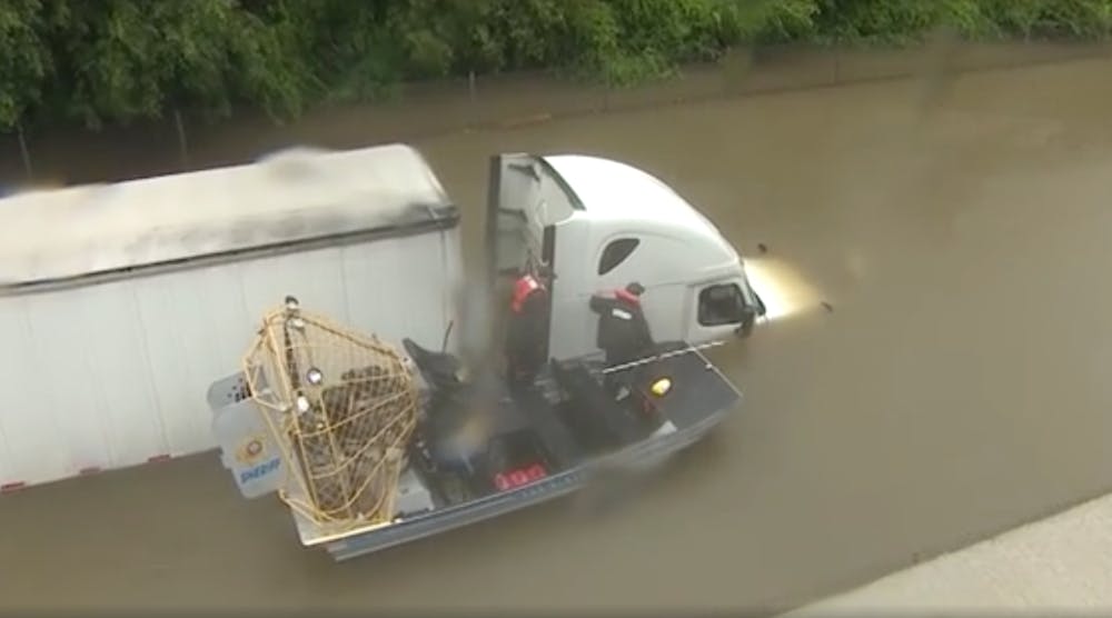 A truck driver is rescued after being stranded on a flooded road in Houston from Hurricane Harvey. (Photo: Brandi Smith)