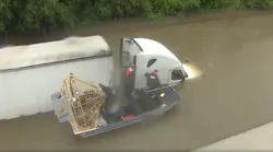 A truck driver is rescued after being stranded on a flooded road in Houston from Hurricane Harvey Photo Brandi Smith