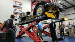 A 1946 Brockway 260XW heavy-duty truck is up on a lift that is being inspected by men during an inspector certification class at the new Automotive Lift Institute&apos;s LiftLab in Cortland, NY. (Photo: Josh Fisher/Fleet Owner)