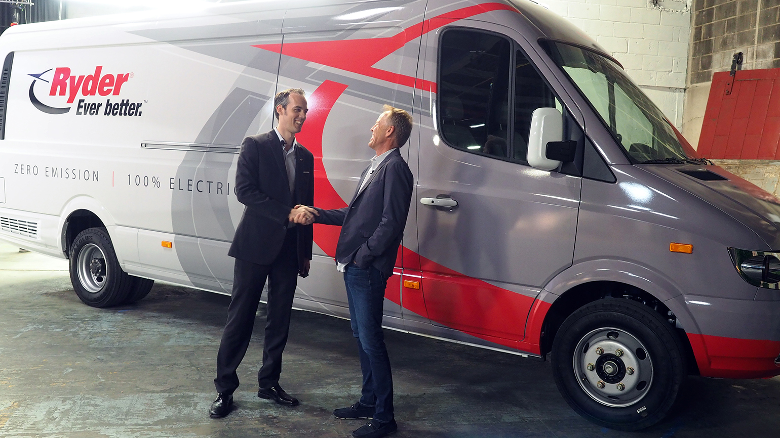 Chanje CEO Bryan Hansel, right, hands over the keys to one of Ryder's first 125 Chanje V8070 panel vans to Ryder's Chris Nordh.
