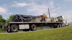 Truck driver tarping Truck driver tarping