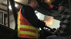 Abe Dunivin of the Oregon Department of Transportation discusses the ELD mandate with a driver who was unable to log into his device, and instead provided paper logs. (Photo: Neil Abt/Fleet Owner)