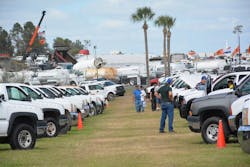 Customers check out pickups that will go up for auction on Saturday, Feb. 24, 2018, at Ritchie Bros.