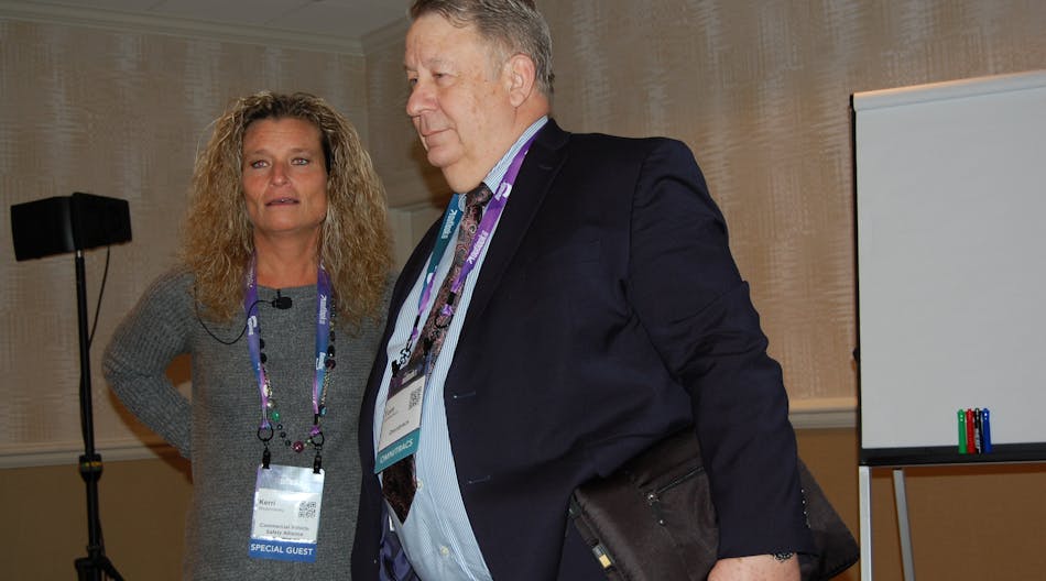 CVSA&apos;s Kerri Wirachowsky (left) confers with Tom Cuthbertson of Omnitracs.