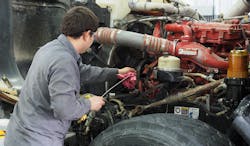 Technician changing oil Technician changing oil