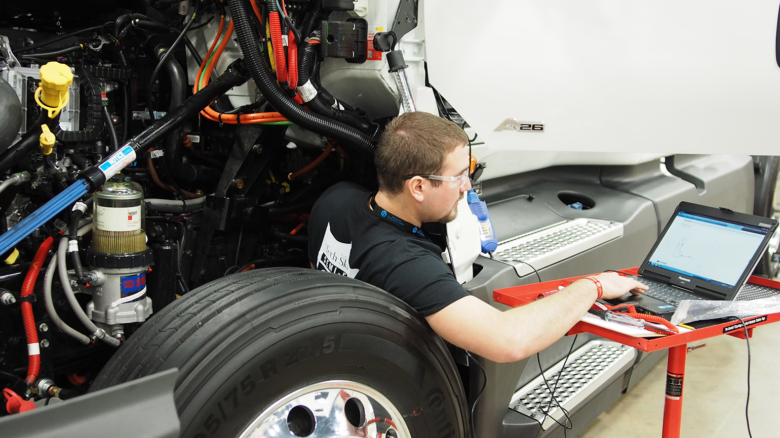 truck technician works on laptop
