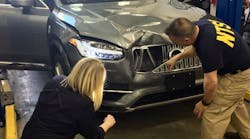 Investigators with the National Transportation Safety Board view the damage on Uber&apos;s self-driving Volvo after the fatal accident.