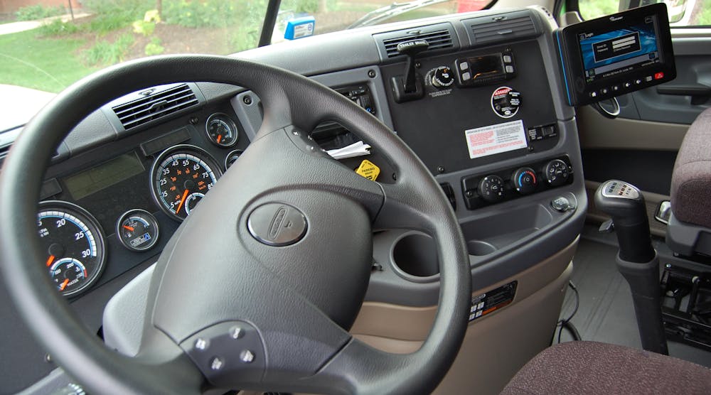 An ELD (upper right) inside a truck cab.