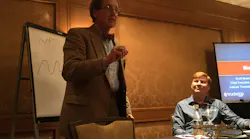 Transportation economist Noeumll Perry briefs supply chain executives as Internet Truckstop Group founder and CEO Scott Moscrip looks on