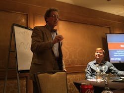 Transportation economist Noeumll Perry briefs supply chain executives as Internet Truckstop Group founder and CEO Scott Moscrip looks on Transportation economist Noeumll Perry briefs supply chain executives as Internet Truckstop Group founder and CEO Scott Moscrip looks on