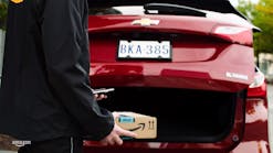 Image from a GM/ Amazon video showing Amazon Key In-Car package delivery being made to the trunk of a Chevrolet vehicle.