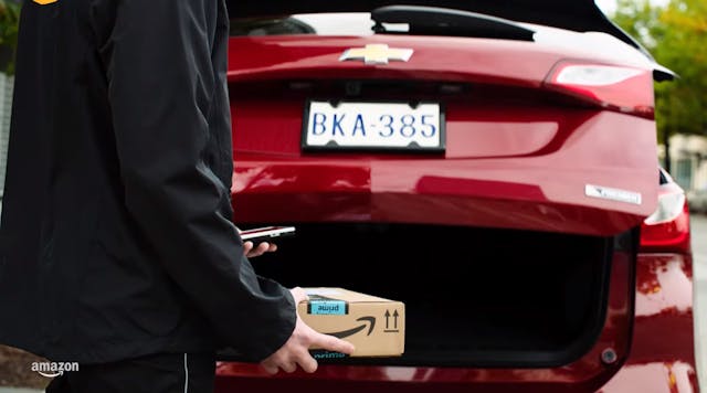 Image from a GM/ Amazon video showing Amazon Key In-Car package delivery being made to the trunk of a Chevrolet vehicle.
