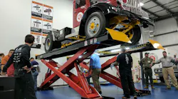 A 1946 Brockway 260XW heavyduty truck is up on a lift that is being inspected by men during an inspector certification class at the new Automotive Lift Institute39s LiftLab in Cortland NY Photo Josh FisherFleet Owner
