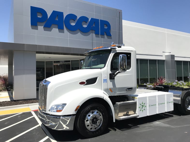 An all-electric Peterbilt truck outside the PACCAR Innovation Center.