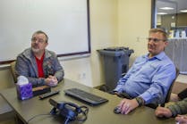 Coaches Denny Kalista (left) and Brad Aimone review video at Central Oregon Truck&apos;s headquarters.