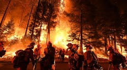 Firefighters battle a wildfire near Redding, CA.