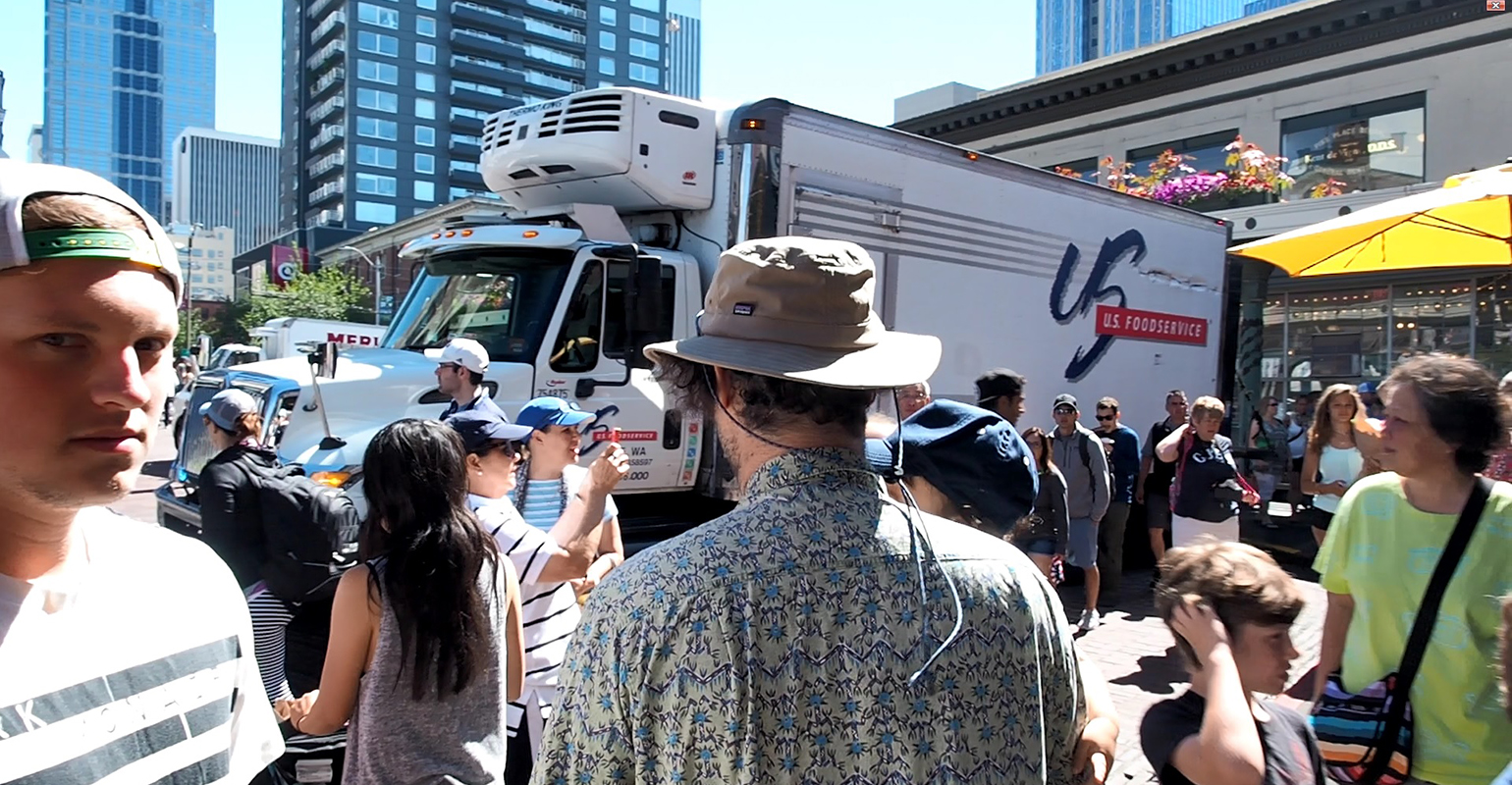 Urban area delivery truck amid heavy pedestrian traffic
