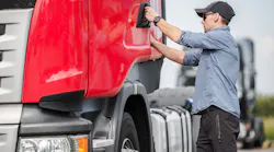 truck driver getting in cab