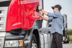 truck driver getting in cab truck driver getting in cab