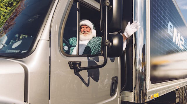 Santa gets behind the wheel of the first Freightliner eM2 delivered to Penske.