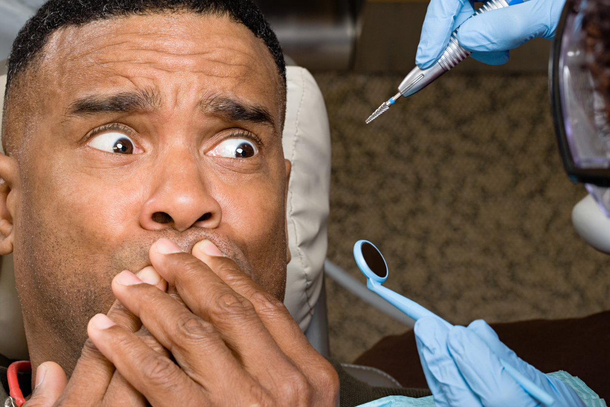dental health man covering mouth