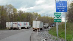Trucks are parked along a rest stop entrance ramp on I-80 in Pennsylvania, where all the truck parking was taken.