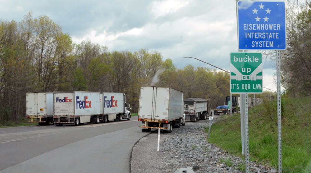 Trucks are parked along a rest stop entrance ramp on I-80 in Pennsylvania, where all the truck parking was taken.