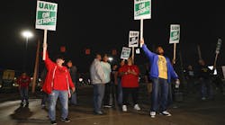 Striking UAW members picket at a gate at the General Motors Flint Assembly Plant.