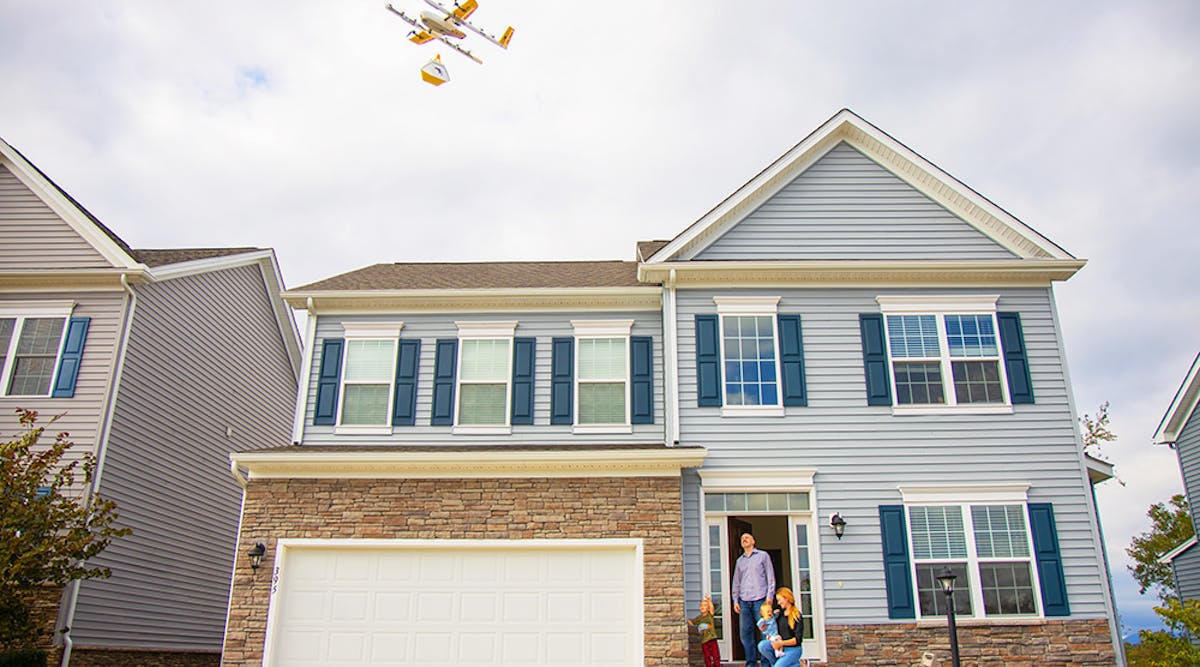 A Wing drone makes a delivery at a house in Virginia.