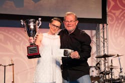 Rebecca Chewning receives the trophy for All-Around Grand Champion of the Hino parts division from Rusty Rush at the annual Rush Tech Skills Rodeo. Rebecca Chewning receives the trophy for All-Around Grand Champion of the Hino parts division from Rusty Rush at the annual Rush Tech Skills Rodeo.