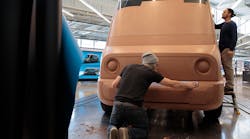 Sculptors smoothing the edges of full-size clay vehicle models of Rivian&apos;s future Amazon electric delivery vans, which are being designed in Plymouth, Mich.
