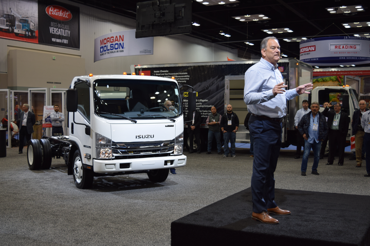 Shaun Skinner, president of Isuzu Commercial Truck of America, and president of Isuzu Commercial Truck of Canada stands in front of the Isuzu NPR-HD truck, during a press conference at the Work Truck Show 2020.