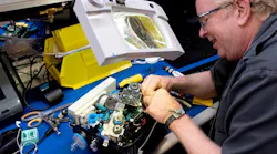 A Ventec Life Systems worker operates on a VOCSN machine, which combines the work of five respiratory medical devices into one.