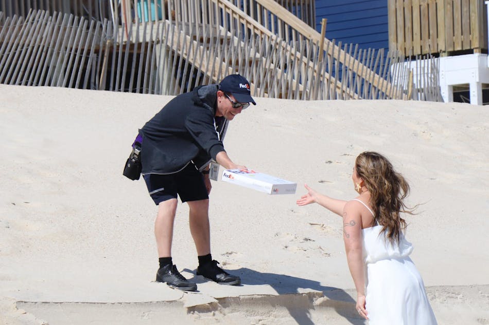 FedEx driver Joe Engel delivers wedding bands to couple during the ceremony.