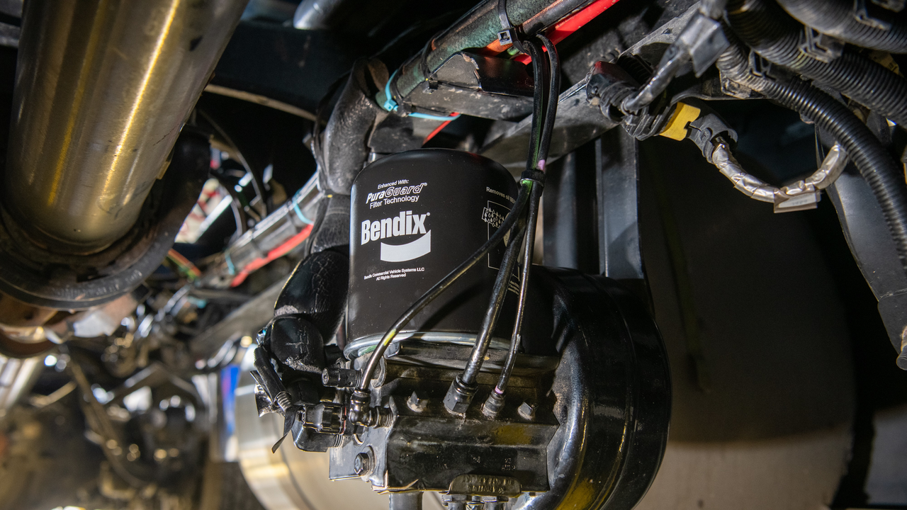 Pictured is a Bendix AD-IS dryer with PuraGuard oil-coalescing filter mounted on a truck. Oil-coalescing filters are essential for trucks with AMTs due to an AMTs&rsquo; need for extremely high-quality air.