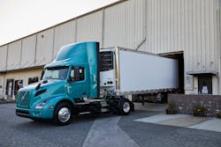 Volvo Vnr Electric 4x2 Tractor With Reefer Trailer Parking At Loading Dock Volvo Vnr Electric 4x2 Tractor With Reefer Trailer Parking At Loading Dock