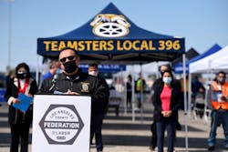 Ron Herrera, Director of the International Brotherhood of Teamsters Ports Division, speaks during a press conference at an outdoor vaccine clinic where 500 COVID-19 vaccines were distributed to port truck drivers.