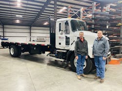 Logan Teinert, fleet manager of Teinert Metals (left), and Randy Teinert, owner (right), with one of two Mack MD6 recently added to their fleet of 18 trucks.