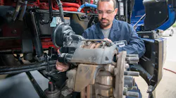 A technician works on air disc brakes.