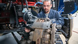 A technician works on air disc brakes. A technician works on air disc brakes.