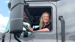 Erica Schueller in the cab of a truck at an media event.
