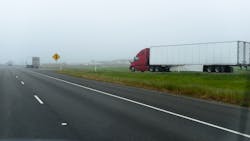 A truck enters an interstate in California, disappearing into the fog. A truck enters an interstate in California, disappearing into the fog.