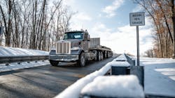 A Peterbilt 567 hauling 140,000 lb. and equipped with the new TX-18 Pro transmission heads downhill on a 15% grade at the Eaton proving grounds. A Peterbilt 567 hauling 140,000 lb. and equipped with the new TX-18 Pro transmission heads downhill on a 15% grade at the Eaton proving grounds.