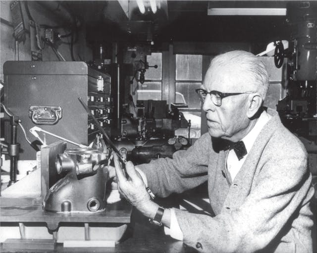 Clessie Cummins in his workshop working on an engine compression brake.