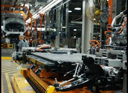 The battery chassis of an E-Transit being assembled on the line at Ford's Claycomo, Missouri, plant. The battery chassis of an E-Transit being assembled on the line at Ford's Claycomo, Missouri, plant.