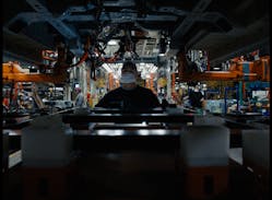 A worker on the line at Ford&apos;s Claycomo, Missouri, assembly plant helping to build the E-Transit, the all-electric version of the car and truck maker&apos;s popular cargo van.