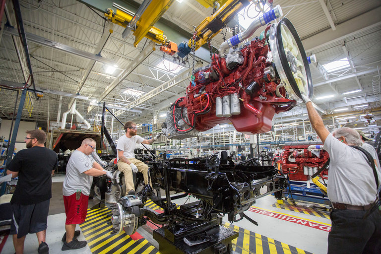 Mack Truck engine plant workers assemble a Class 8 diesel engine. Mack Truck engine plant workers assemble a Class 8 diesel engine.