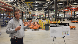 During a March 23 plant tour, Stephen Mudd, area director for general assembly, points out the facility's manufacturing execution system (MES), which can log all equipment defects electronically and pull various reports and information from some 60,000 different parts that go into every truck.